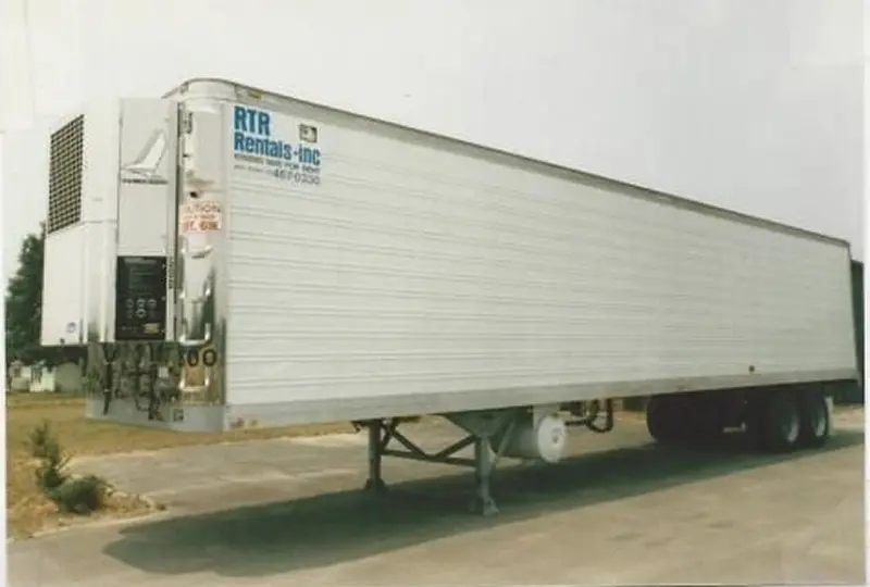 44image_desktop (1) Long white freight trailer parked on road.
