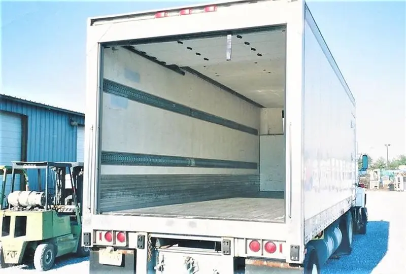 555image_desktop (1) Empty truck trailer with open rear door.