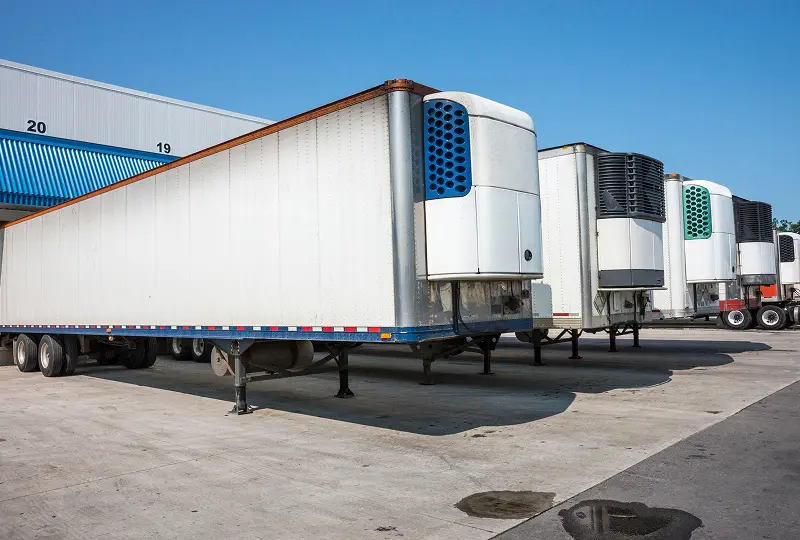 GettyImages-506577097 Refrigerated trailers parked at distribution center.