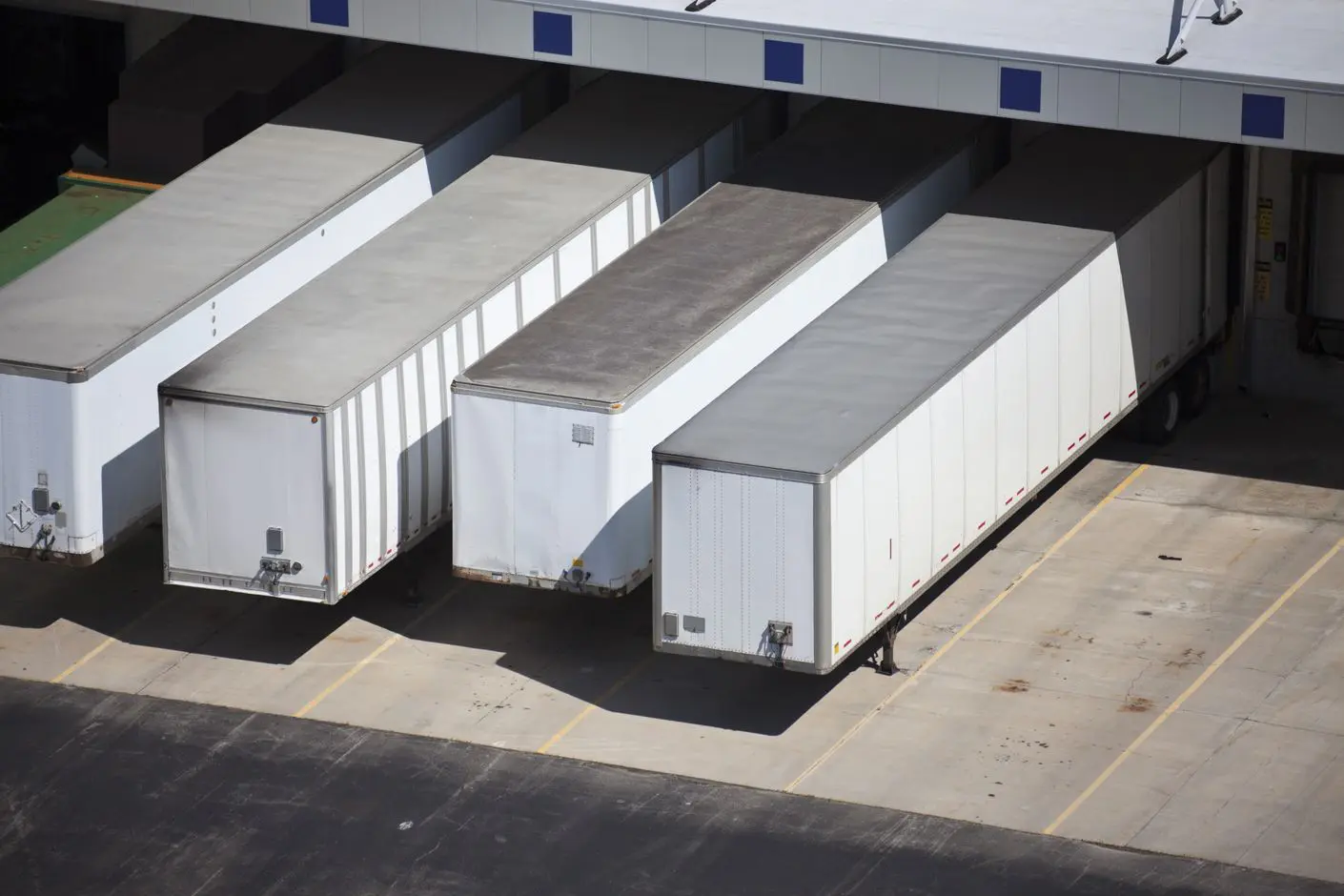 image_desktop Truck trailers parked at loading dock.